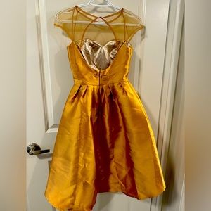 Gold princess dress. High low cut runs around the hem. Brand new with tags